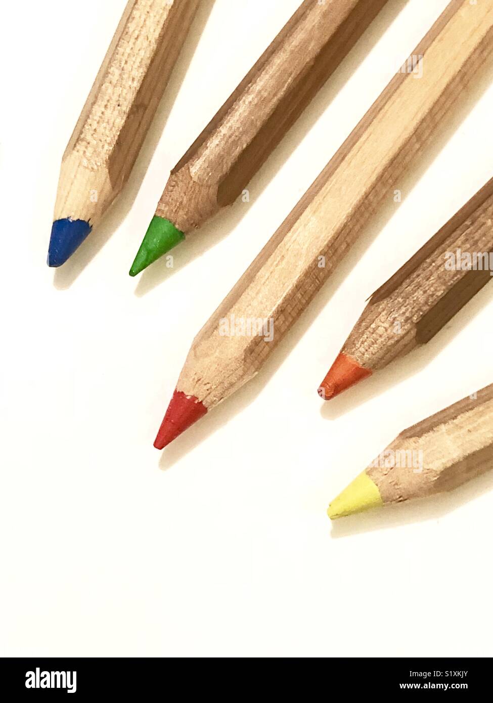 Five colored pencils scattered Stock Photo