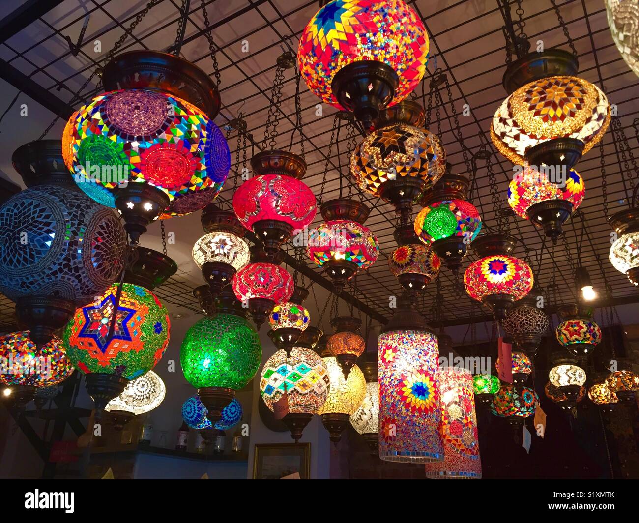 Handmade Turkish glass lamps hanging in a cozy coffee shop in Istanbul