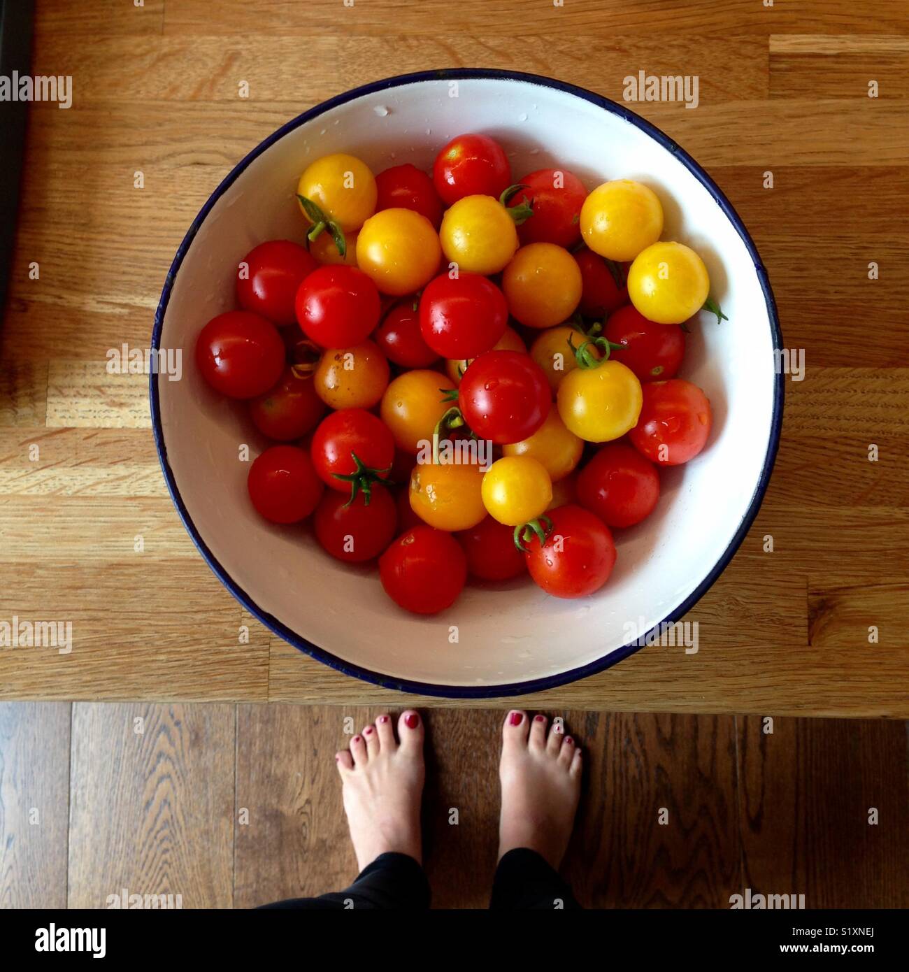 Bowl full of sweet yellow and red cherry tomatoes Stock Photo - Alamy