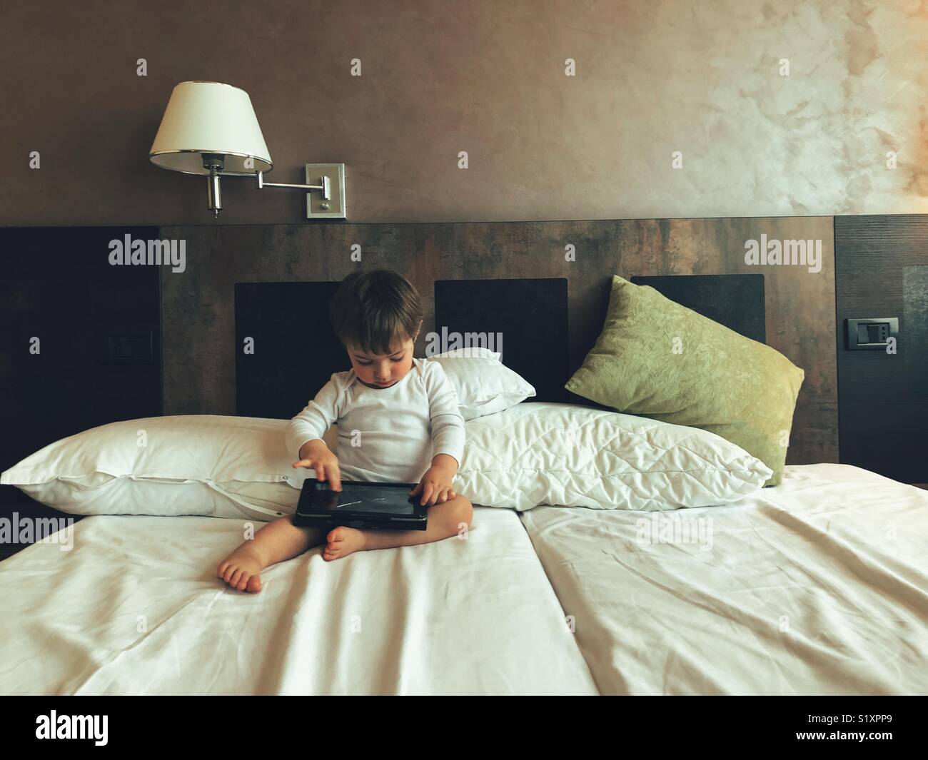 Baby boy using a digital tablet - Smartphone Captured Stock Image