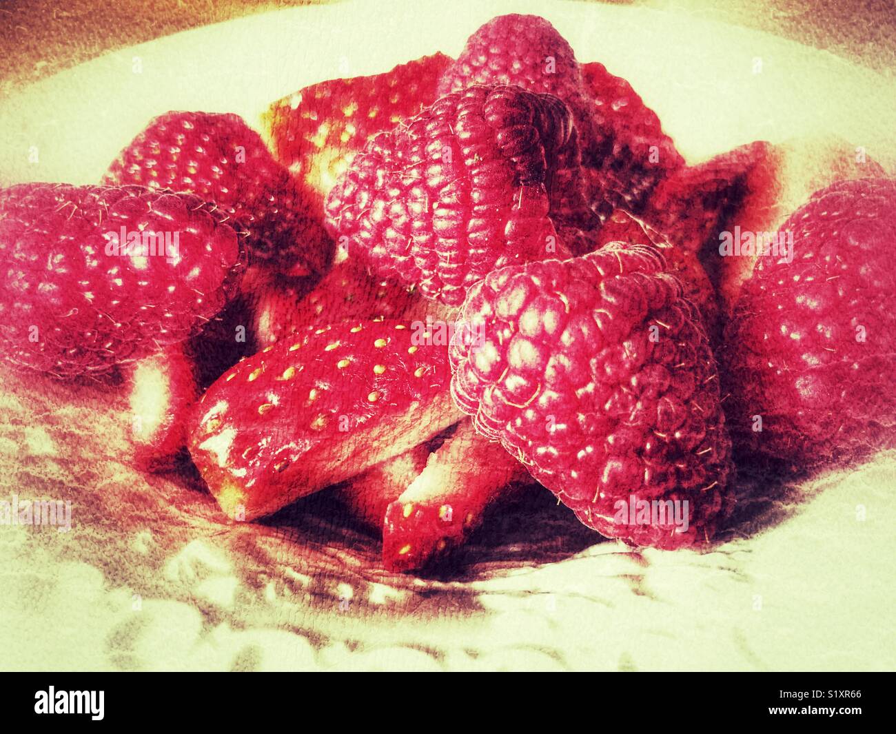 Strawberries and raspberries on a plate, close up - Smartphone Captured Stock Image