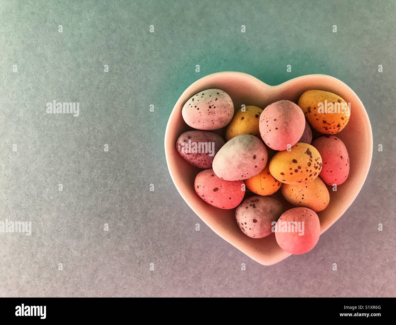 Chocolate Easter eggs in a heart shaped ceramic dish - Smartphone Captured Stock Image