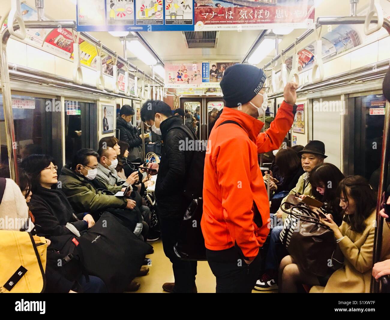 Passengers on the Fukuoka subway wearing masks as protection from flu viruses. - Smartphone Captured Stock Image