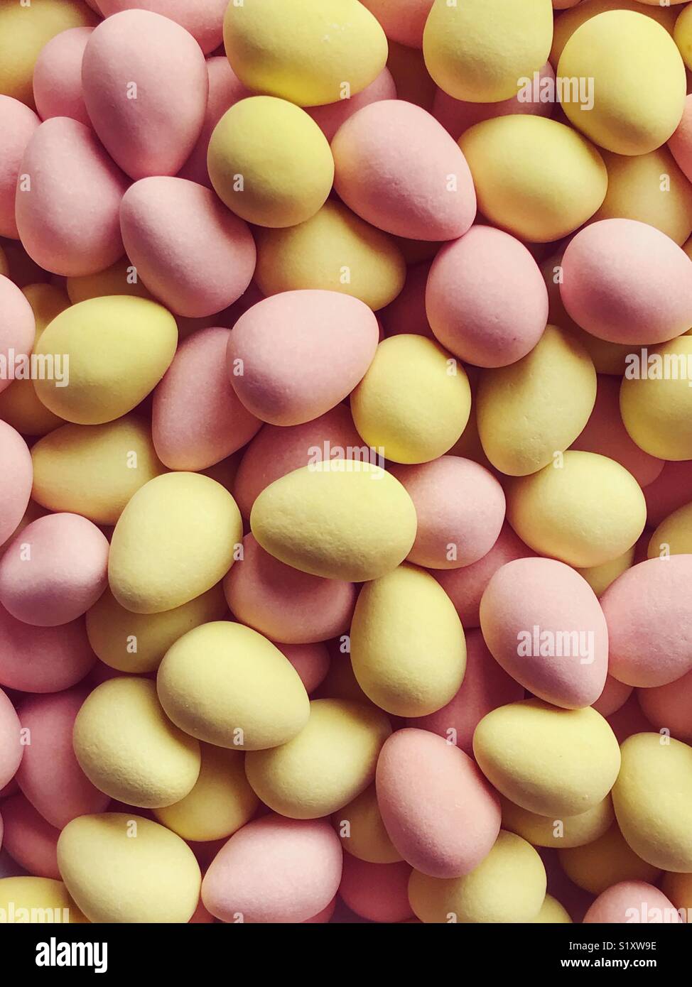 Pink and yellow sugar-coated chocolate mini eggs. - Smartphone Captured Stock Image