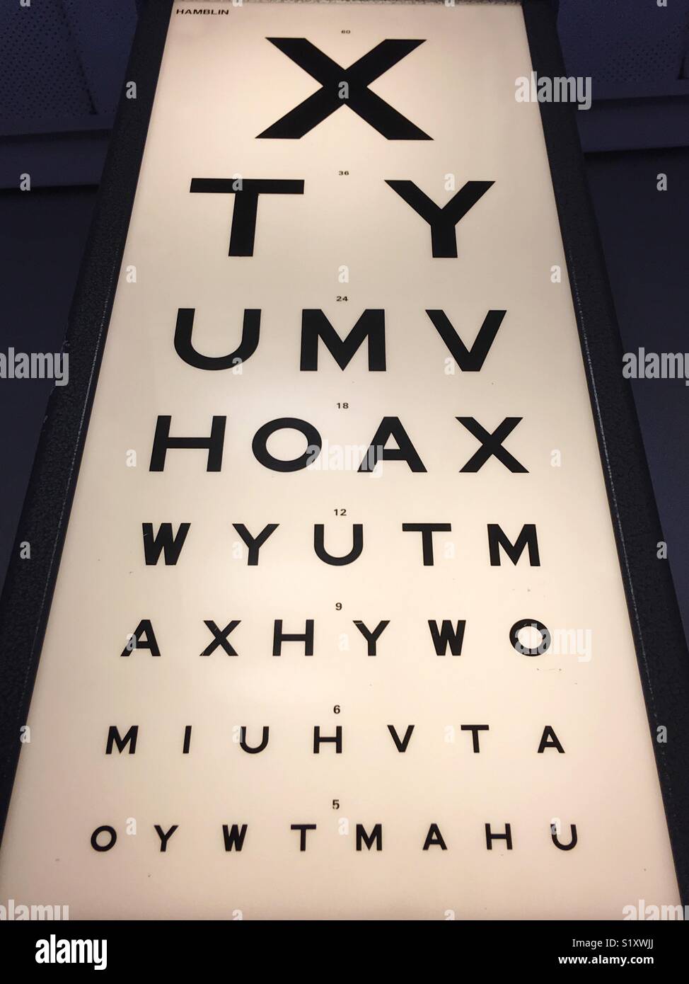 Eye test board on a wall. Stock Photo