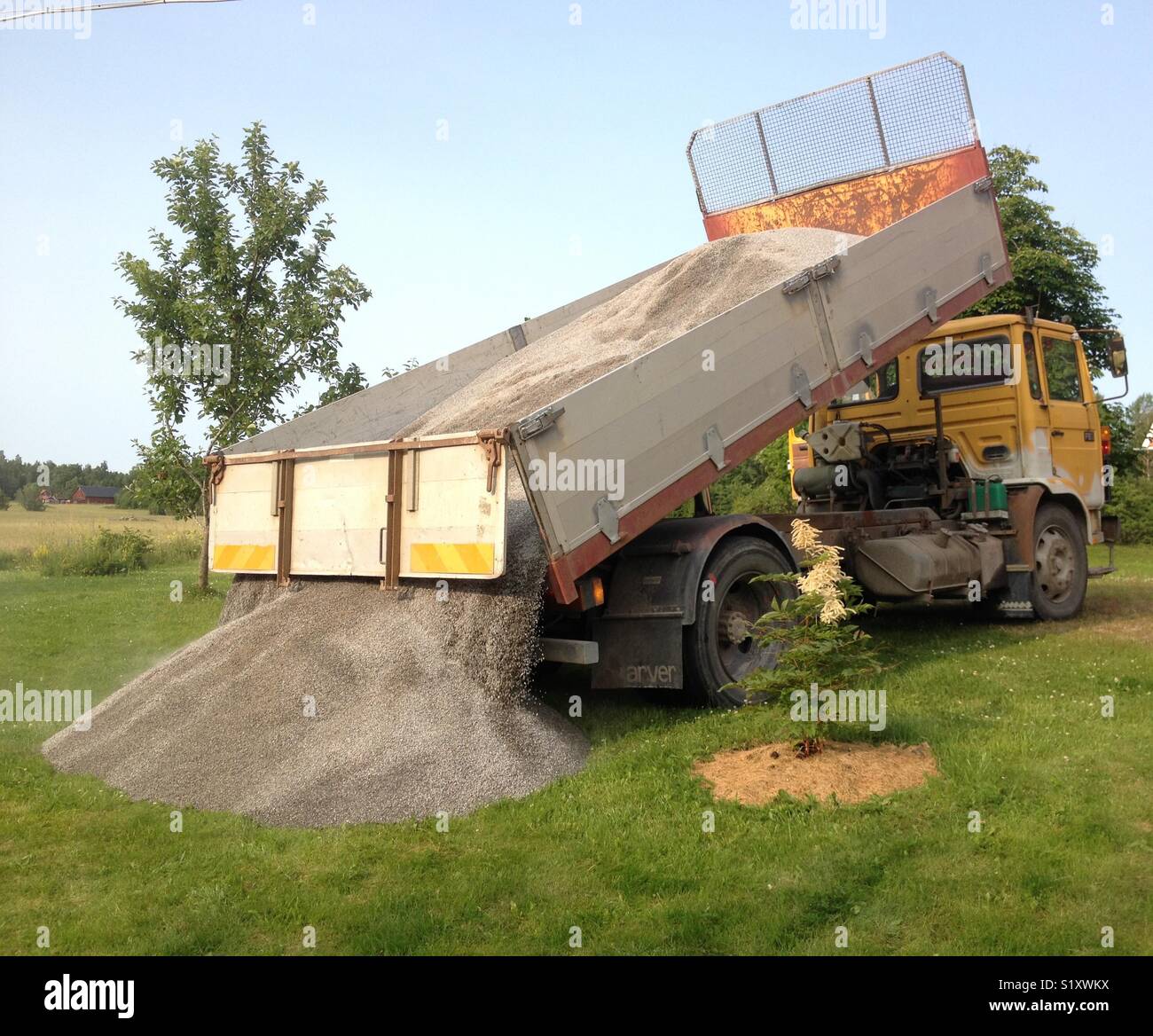 Gravel truck drops load Stock Photo Alamy