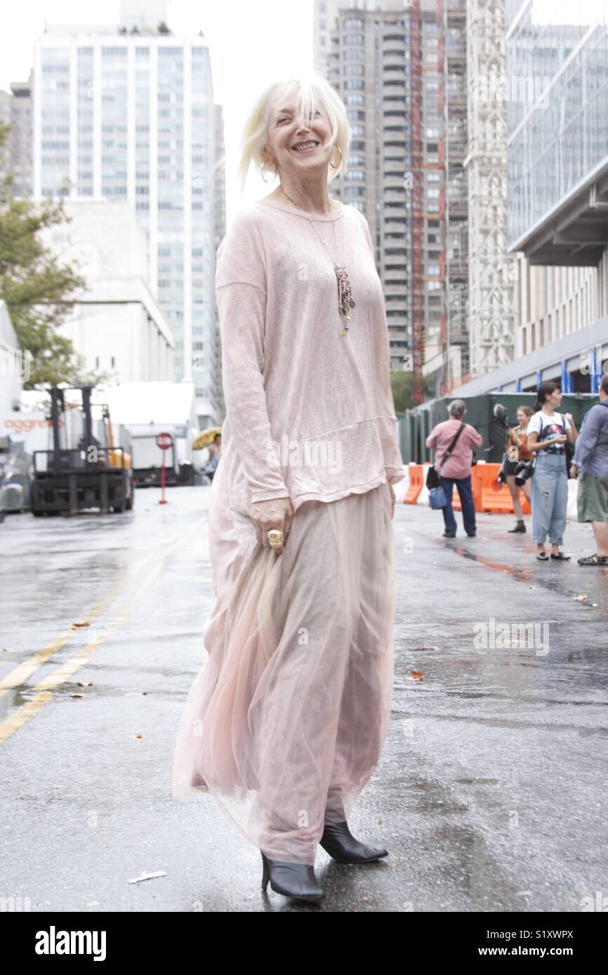 Senior citizen smiling outdoors during New York fashion week - Smartphone Captured Stock Image