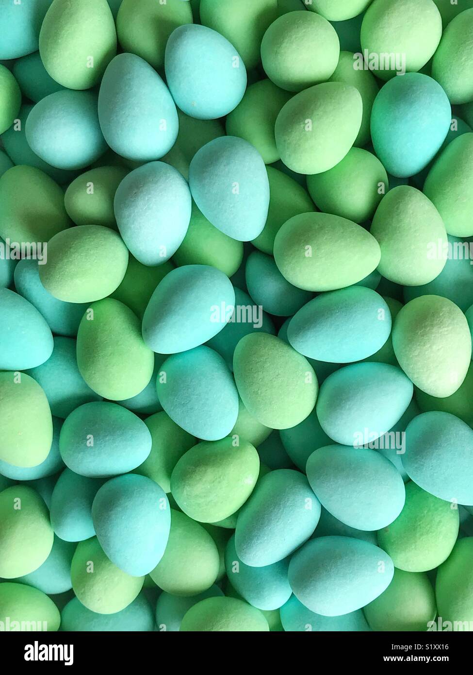 Blue and green sugar-coated chocolate mini eggs. - Smartphone Captured Stock Image