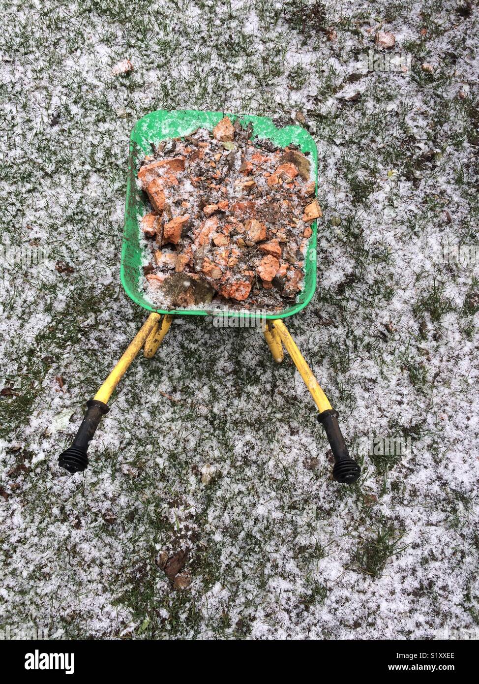 Wheelbarrow in snow Stock Photo