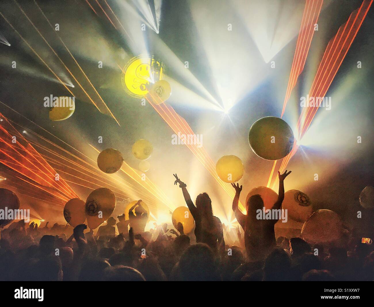 Concert goers enjoying giant balloons - Smartphone Captured Stock Image