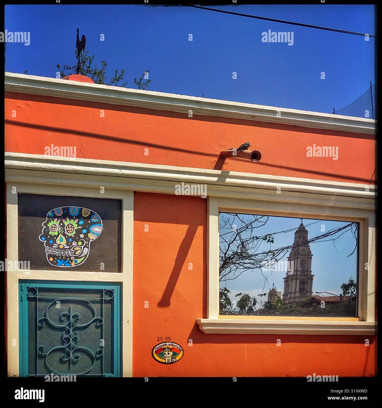The exterior wall of an Ajijic home is decorated with a sugar skull
