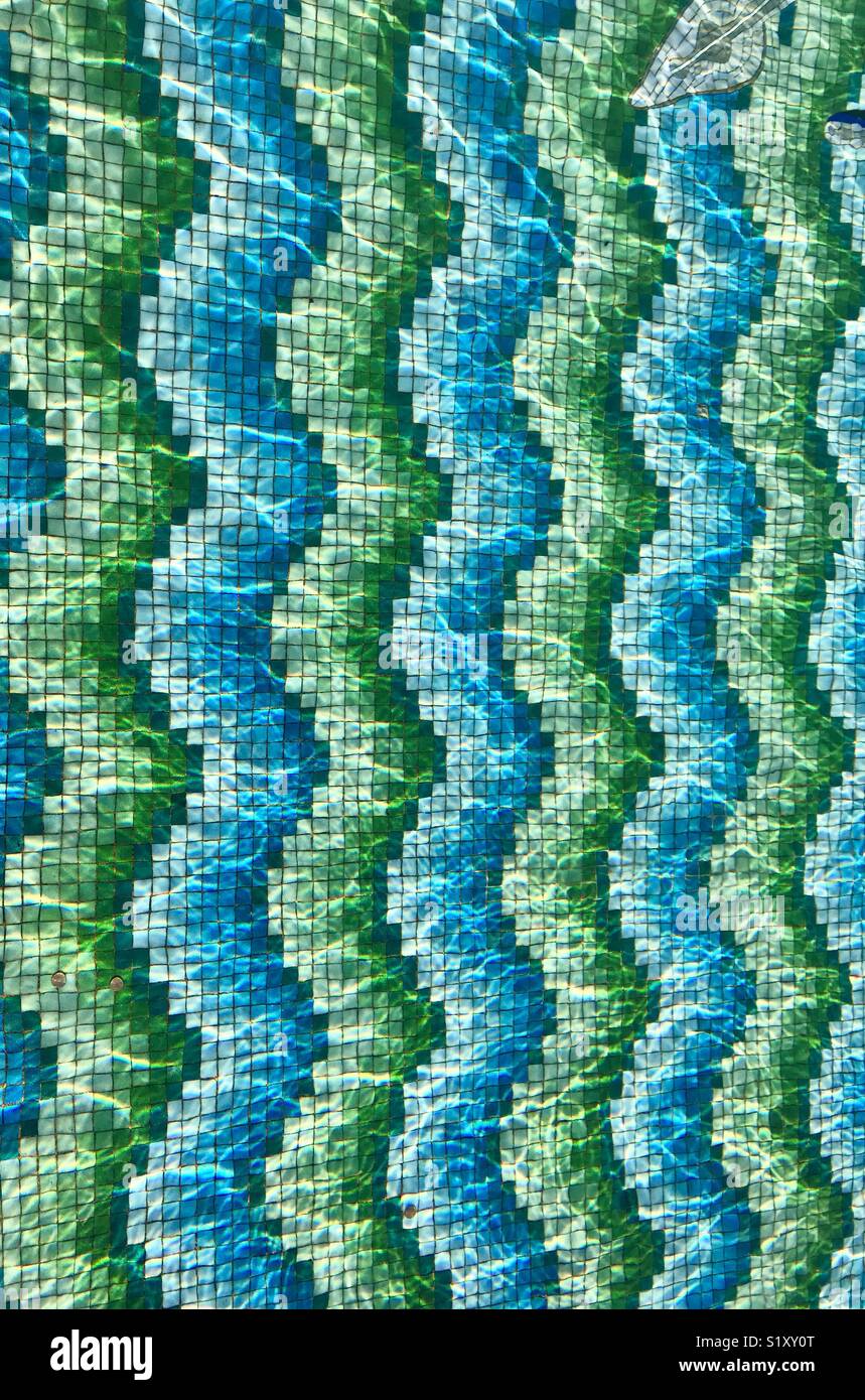 Pattern formed by tiny coloured mosaic tiles on the bottom of a water feature - Smartphone Captured Stock Image