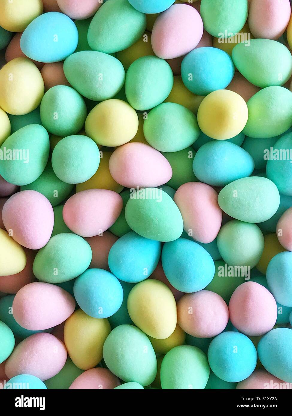 Pink, yellow, blue, and green sugar-coated chocolate mini eggs. - Smartphone Captured Stock Image