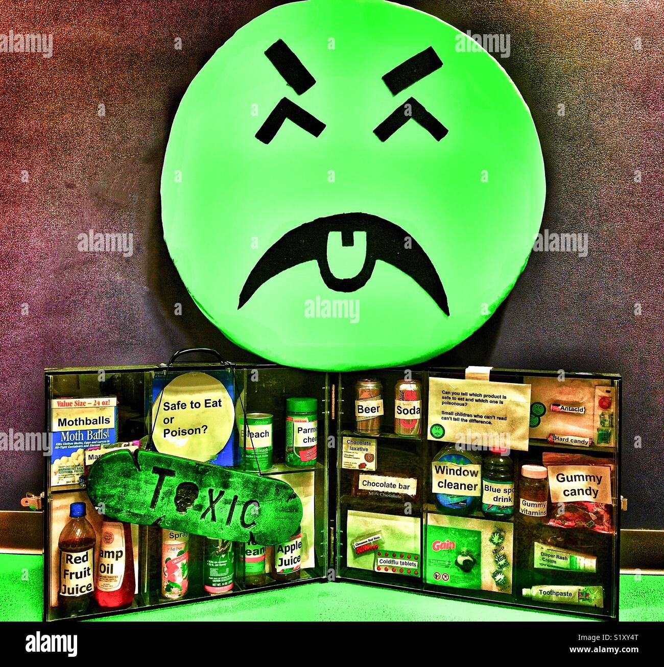Mr YUK with a display of household objects that can be confused with dangerous substances by children Stock Photo
