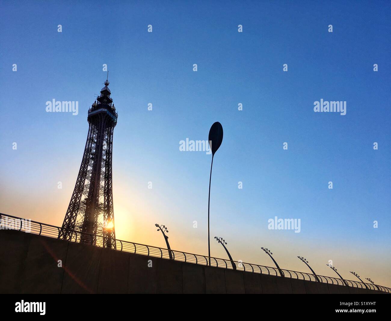 Blackpool Tower and promenade lights in silhouette against a vivid blue sky - Smartphone Captured Stock Image