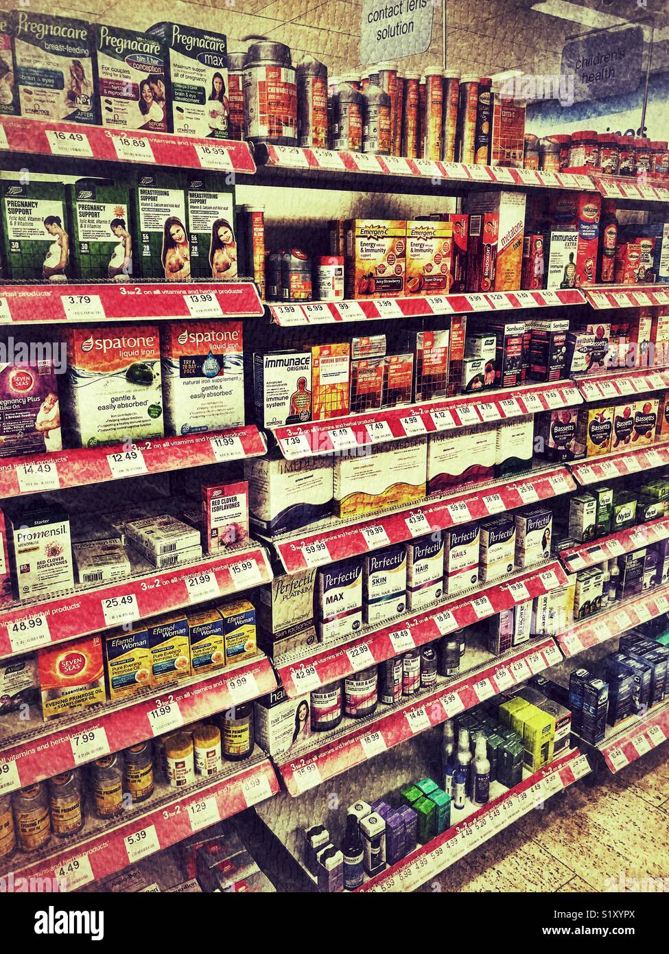 Boots the Chemist, interior, well stocked shelves with a variety of OTC medications - Smartphone Captured Stock Image