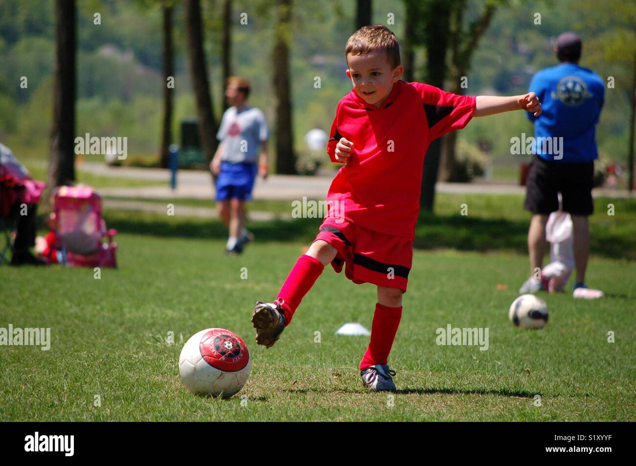 Child Kicking Football Stock Photo Alamy