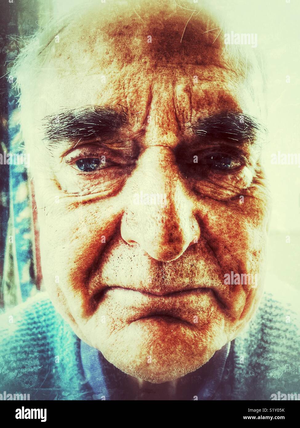 Senior man, portrait indoors - Smartphone Captured Stock Image