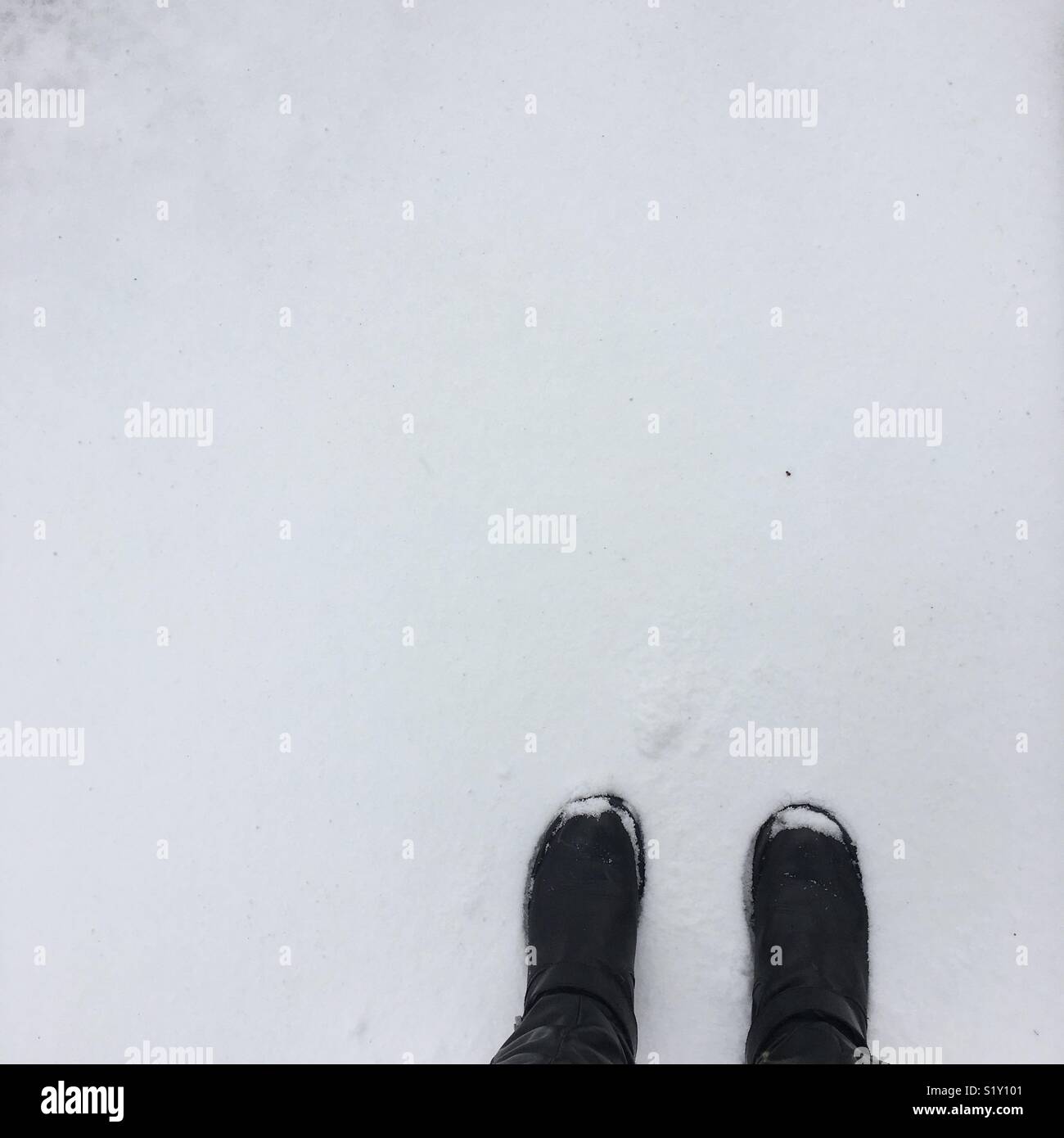 Black boots in snow Stock Photo Alamy