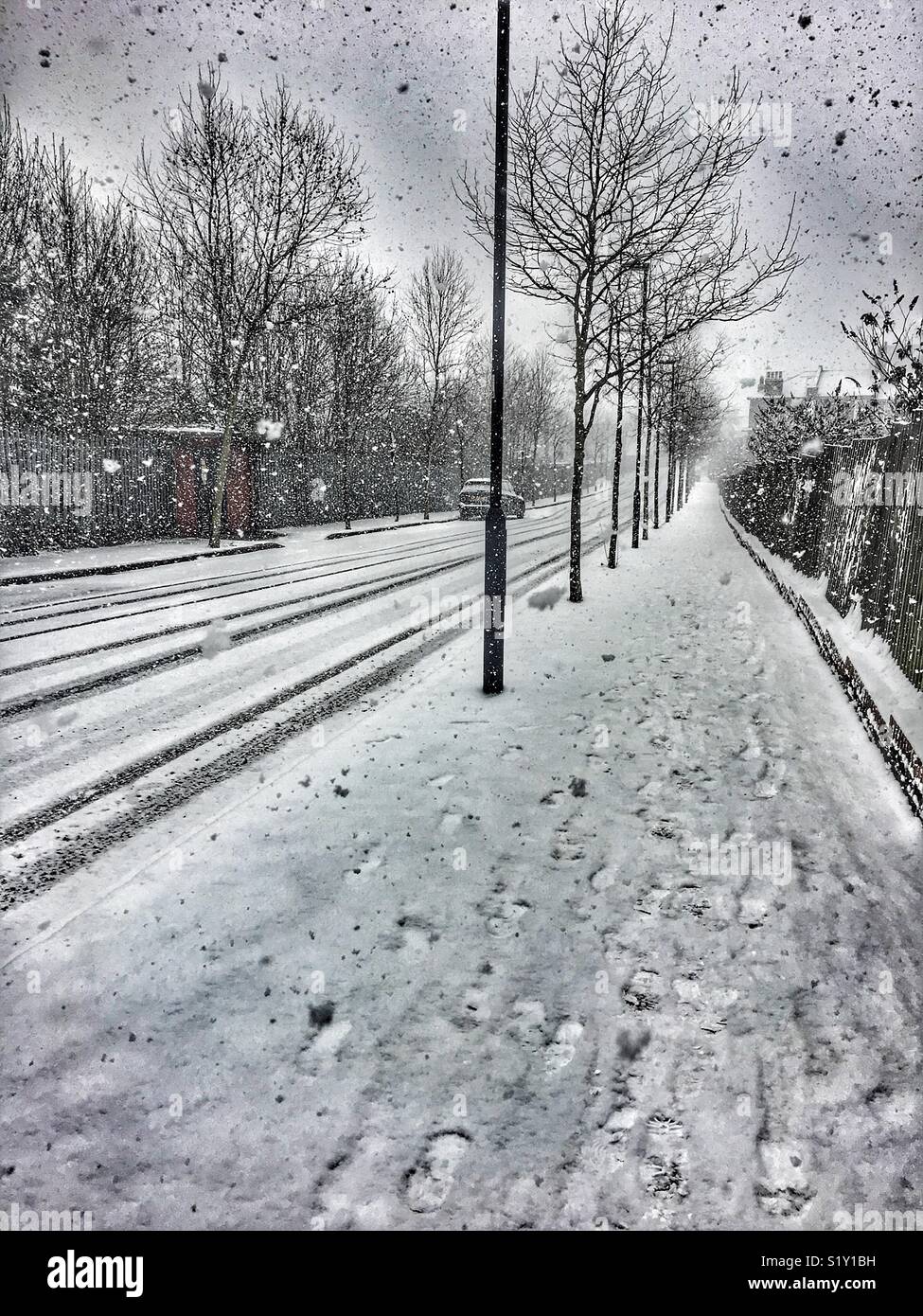Beast from the East. City street scene with heavy snow, north London, England, 28 February 2018. Station Road, London, N7 - Smartphone Captured Stock Image