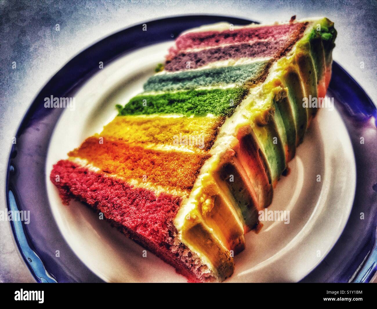 Slice of rainbow cake on a plate - Smartphone Captured Stock Image