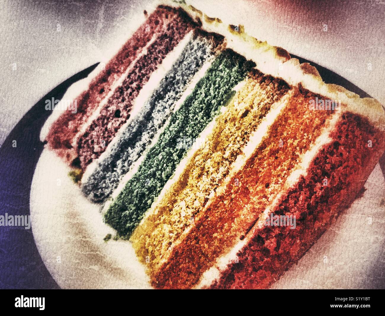 Slice of rainbow cake on a plate, close-up - Smartphone Captured Stock Image