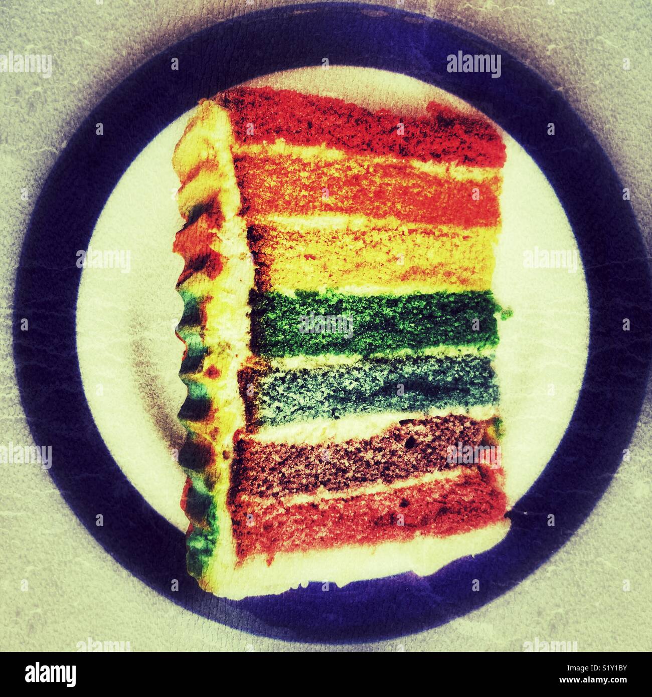 Slice of rainbow cake on a plate, close-up, high angle view - Smartphone Captured Stock Image