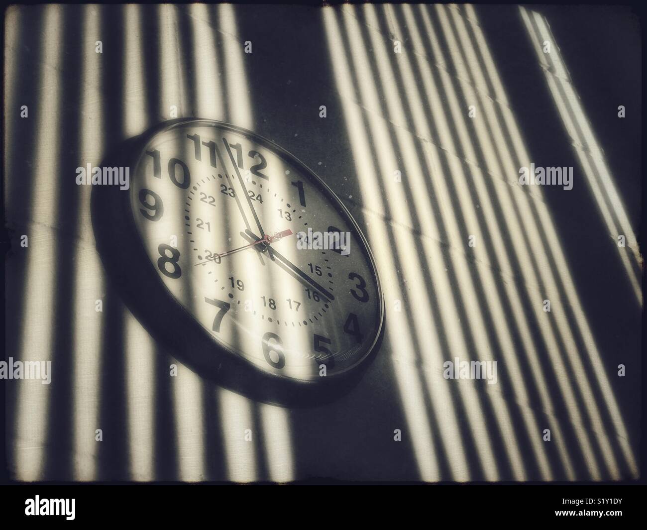 Institutional type clock on wall with shadows - Smartphone Captured Stock Image