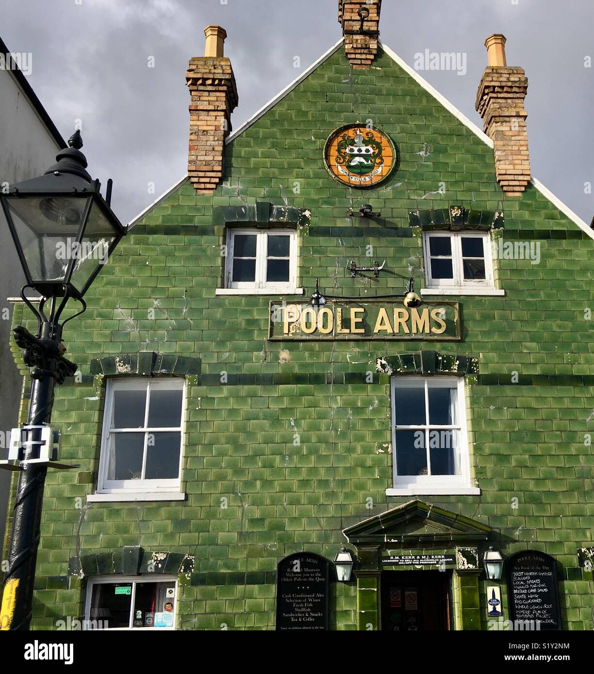 Poole Arms public house, Poole, Dorset, an historic building covered in green ceramic tiles. Stock Photo