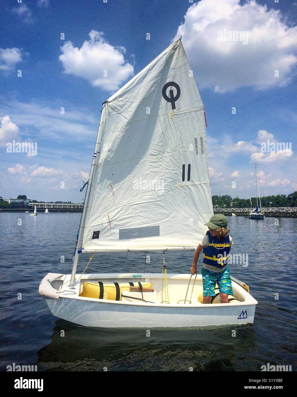Child learning to sail a boat Stock Photo Alamy
