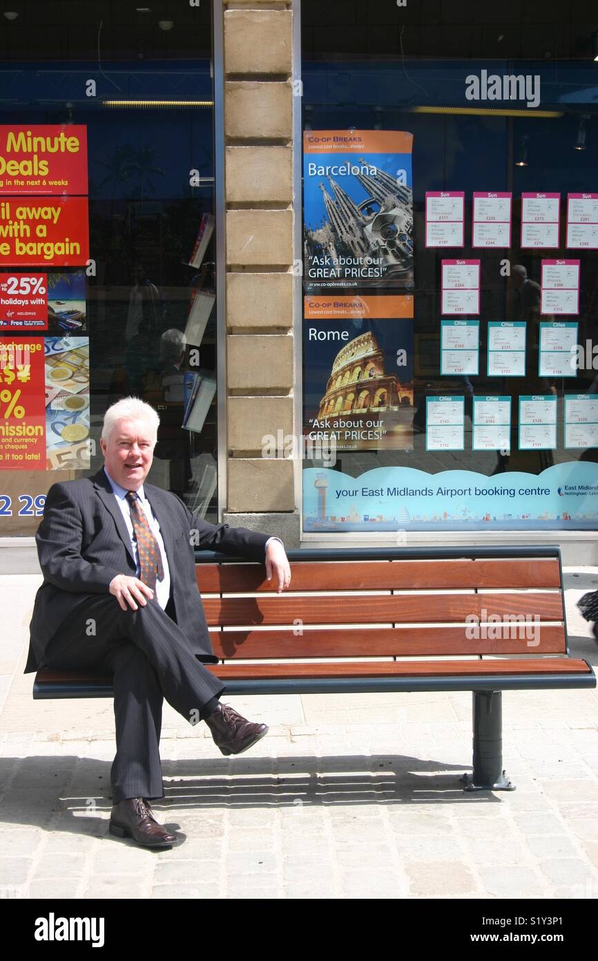 Middle aged suited man on a bench. John Forkin of Marketing Derby - Smartphone Captured Stock Image