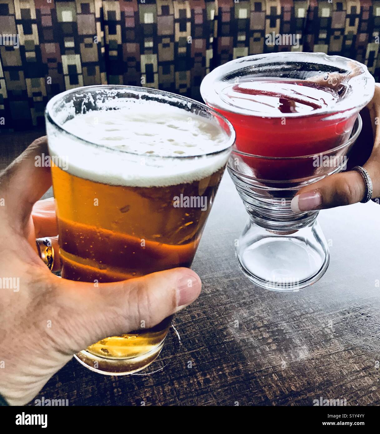 A couple celebrating with cold adult beverages. Stock Photo