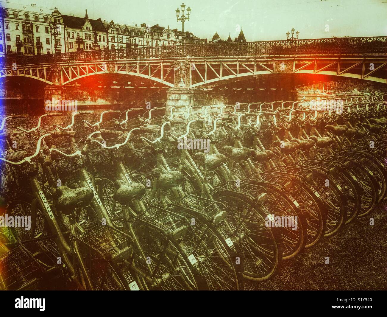 Rows of rental bikes and Djurgardsbron (Djurgarden Bridge), Djurgarden, Stockholm, Sweden, Scandinavia - Smartphone Captured Stock Image