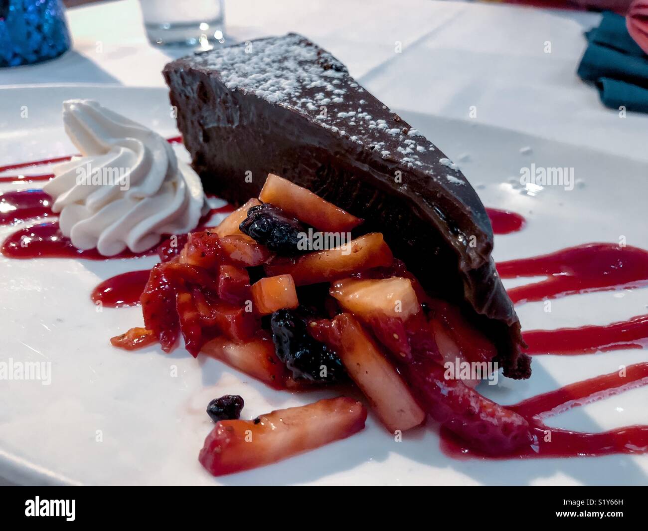 Chocolate tart with raspberry sauce and mixed berries. Stock Photo