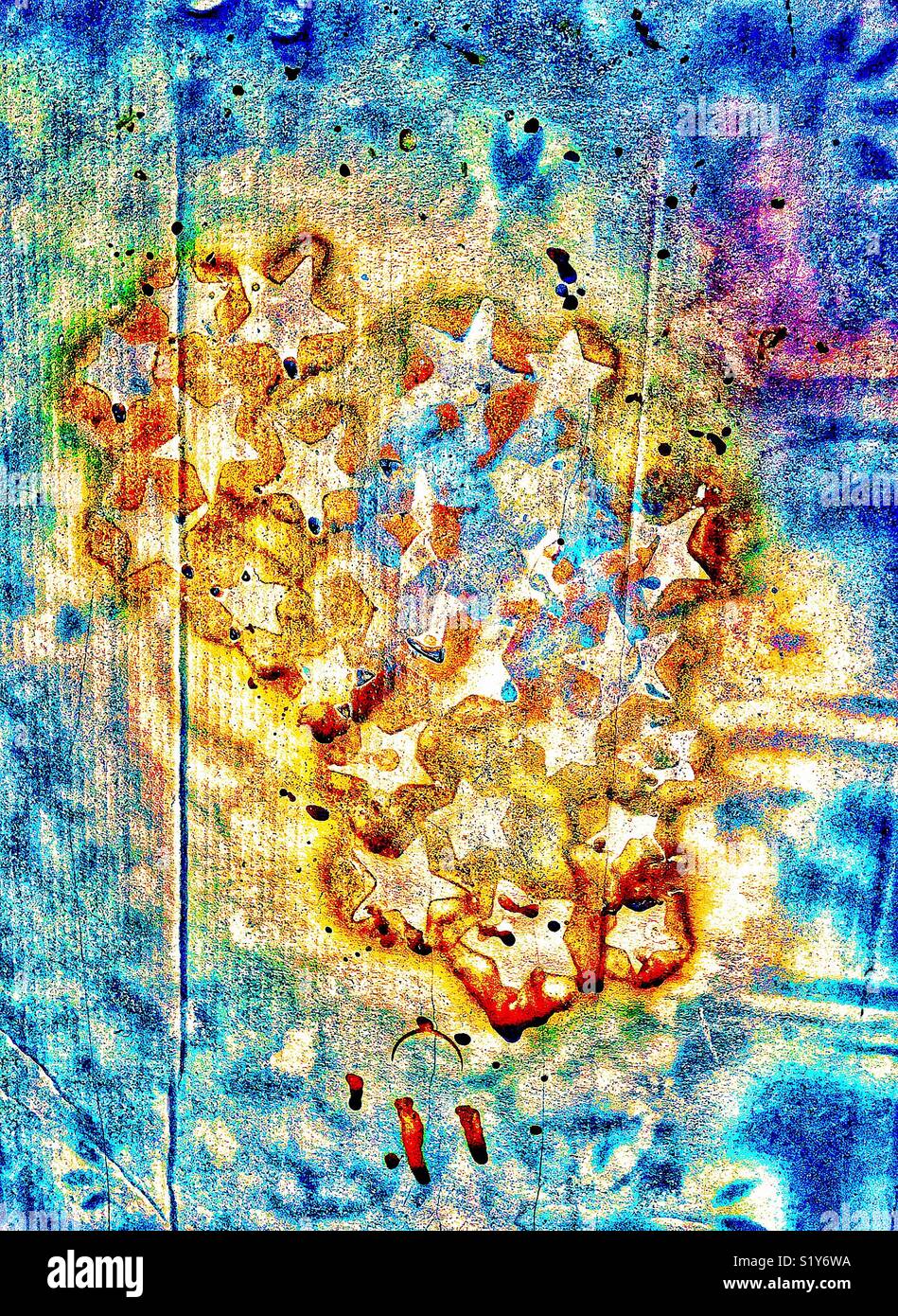 Interesting spray painted pattern of gold paint and stars on cardboard with multicolored background - Smartphone Captured Stock Image