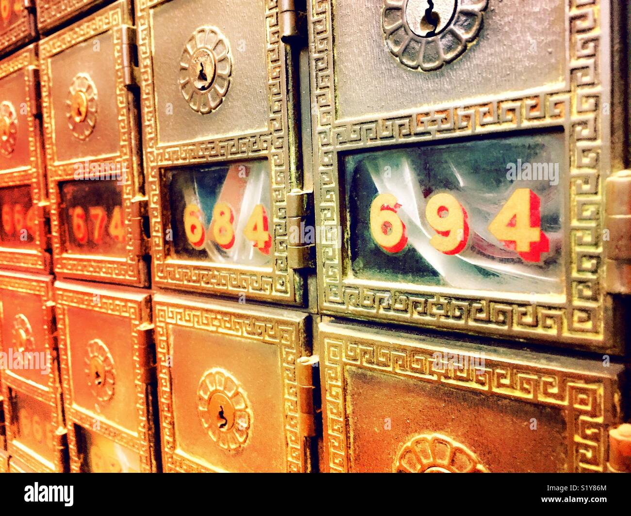 Rows vintage post office boxes with glass doors and letters inside, United States. - Smartphone Captured Stock Image