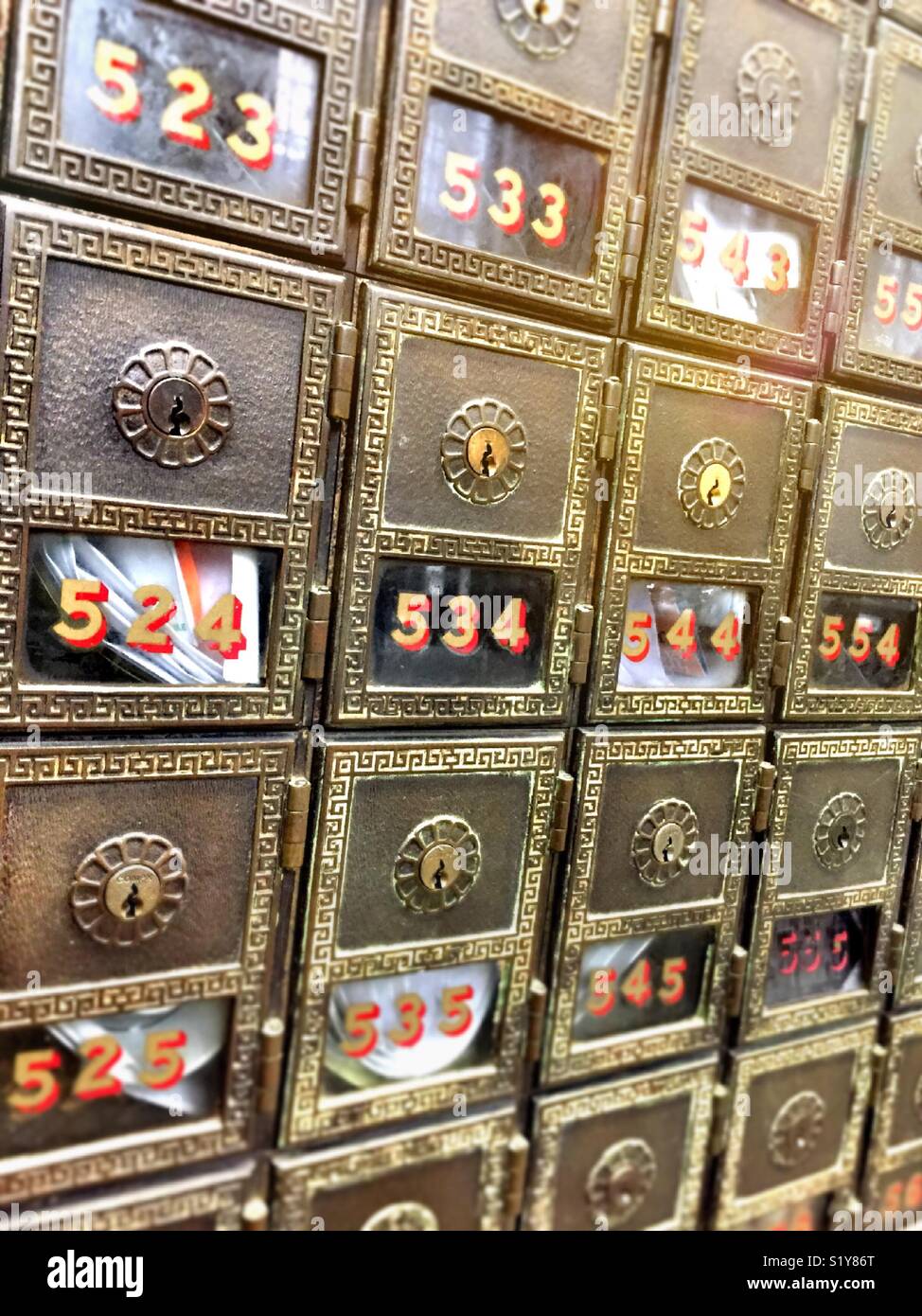 Rows vintage metal post office boxes, in large post office, USA - Smartphone Captured Stock Image