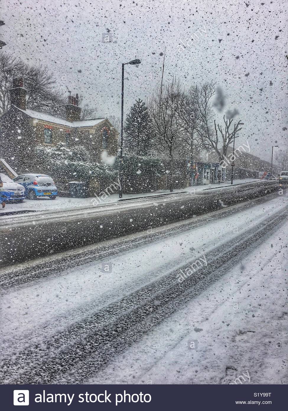 Street scene and heavy snowfall in London, N7 during the Storm From The East blizzard in March 2018. - Smartphone Captured Stock Image