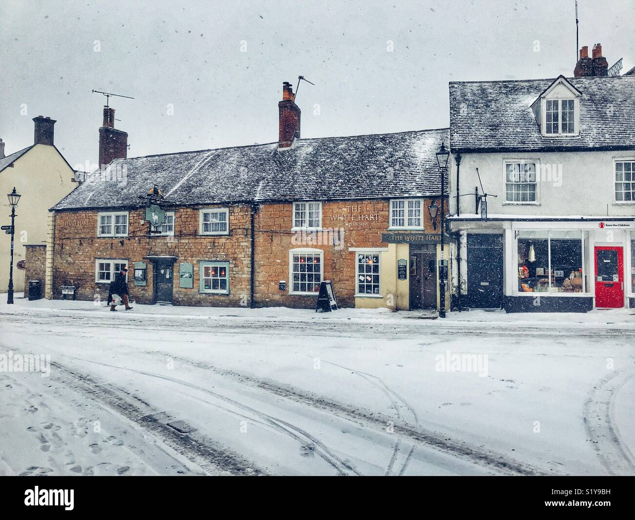 The White Hart Pub in Cheap Street , Sherborne, Dorset, England, during the blizzard of Storm Emma, March 2018 - Smartphone Captured Stock Image