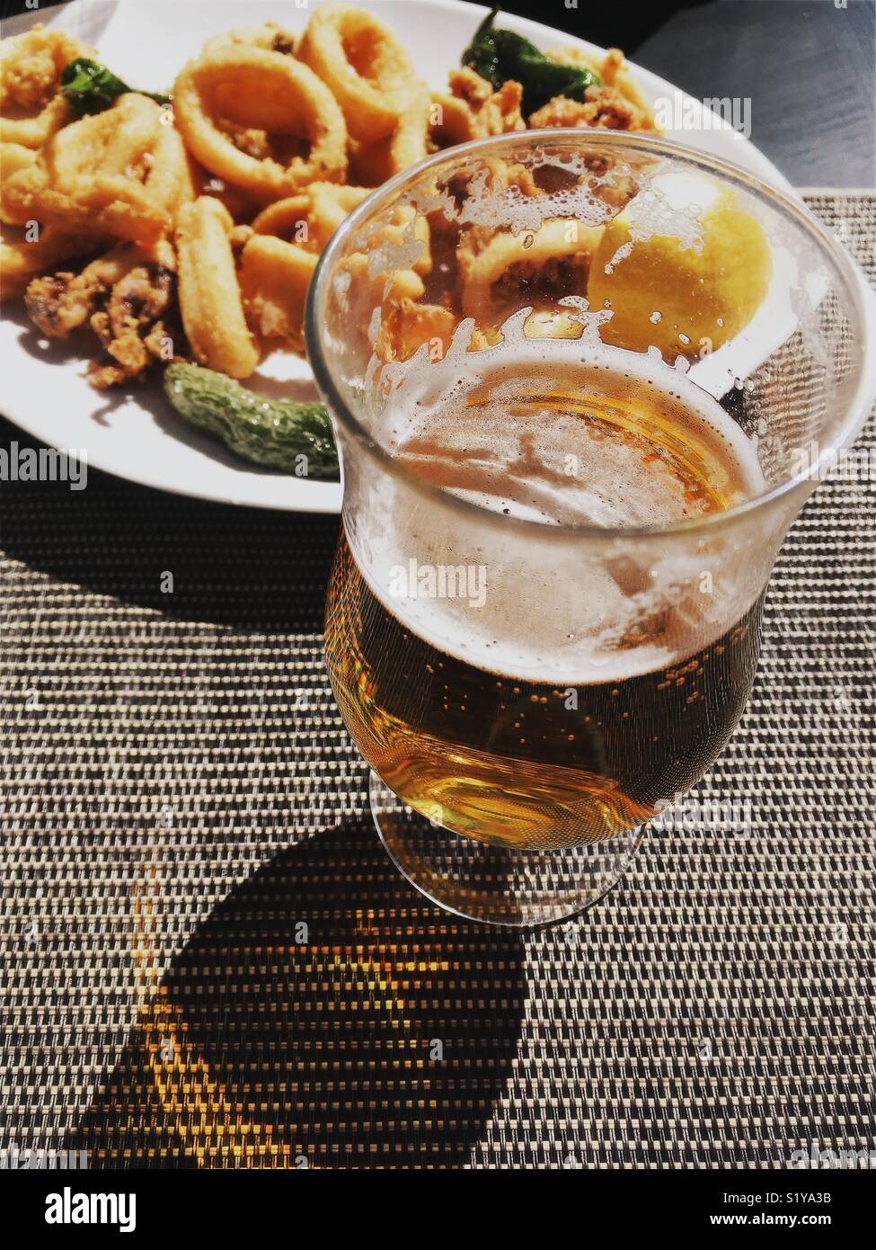 Glass of beer and calamari dish - Smartphone Captured Stock Image
