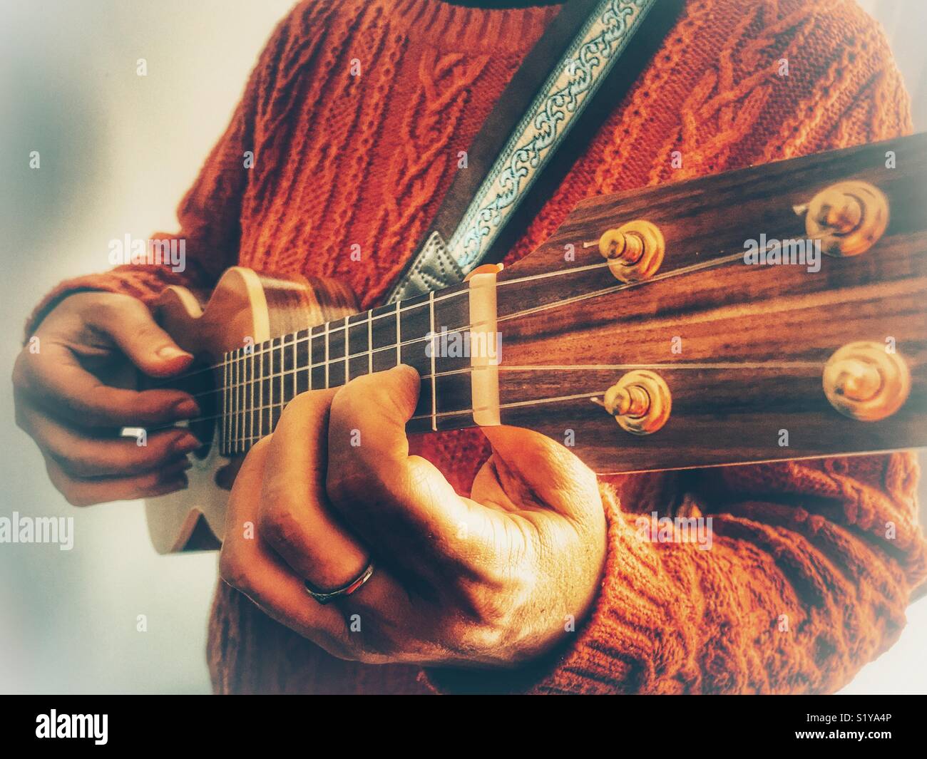 Woman playing a soprano ukulele - Smartphone Captured Stock Image