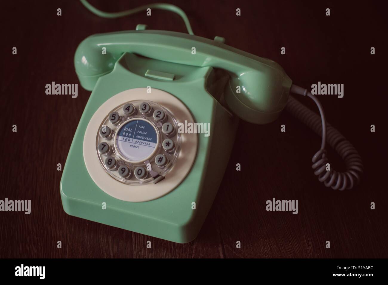 A vintage, old fashioned British telephone in a retro style and with a circular dial - Smartphone Captured Stock Image