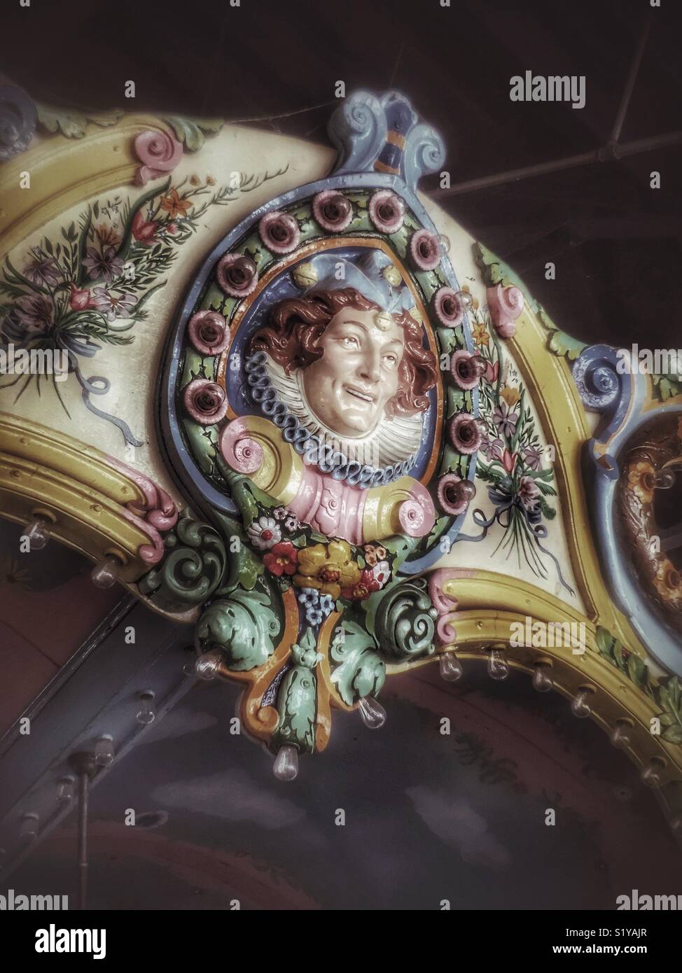 Face of a jester on vintage carousel - Smartphone Captured Stock Image