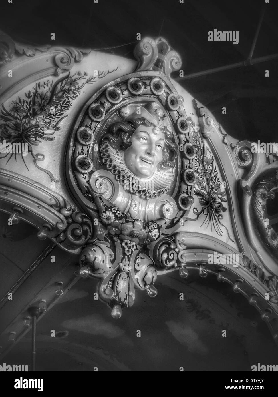 Black and white face of a jester on vintage carousel - Smartphone Captured Stock Image