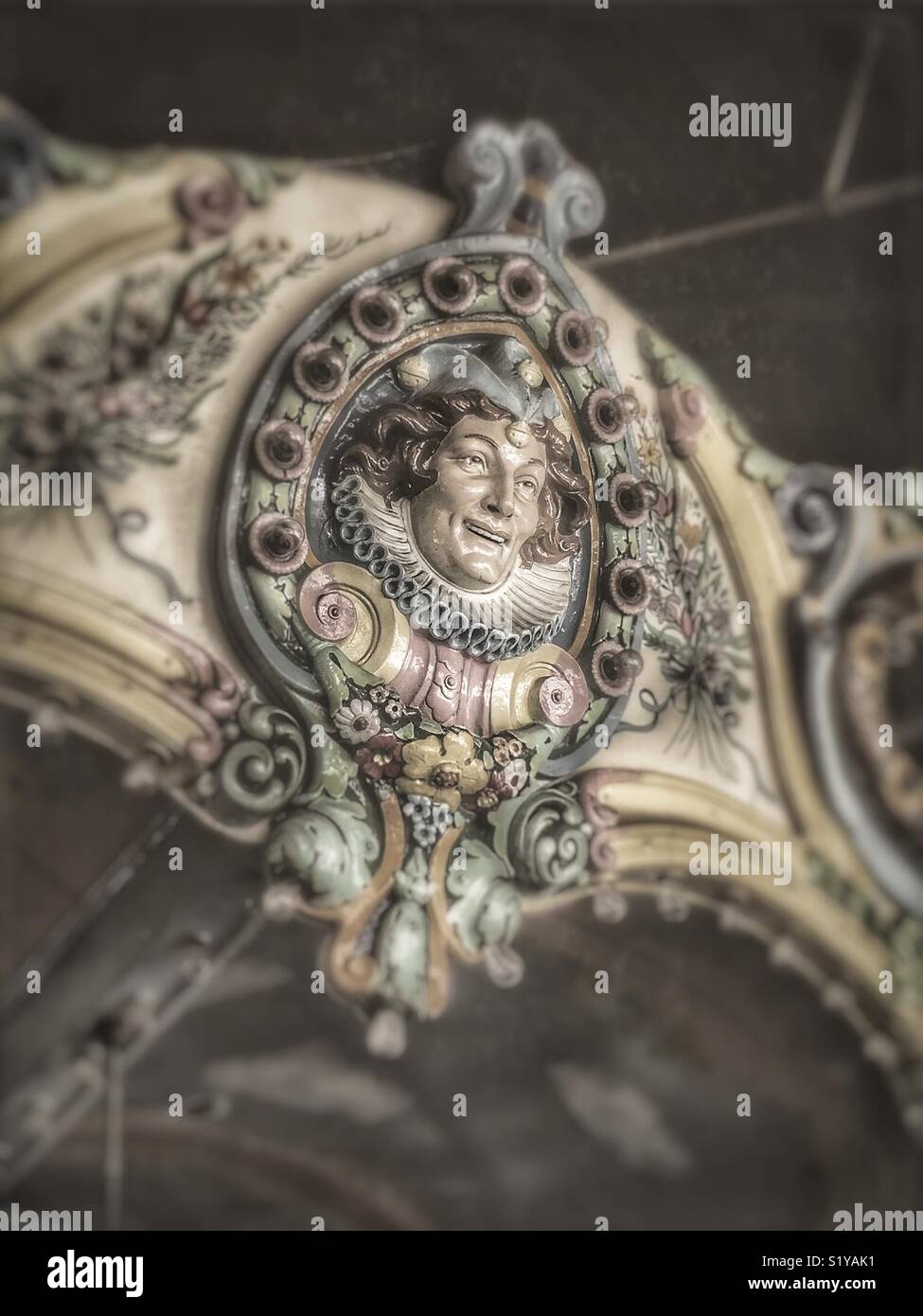 Face of a jester on a vintage carousel - Smartphone Captured Stock Image