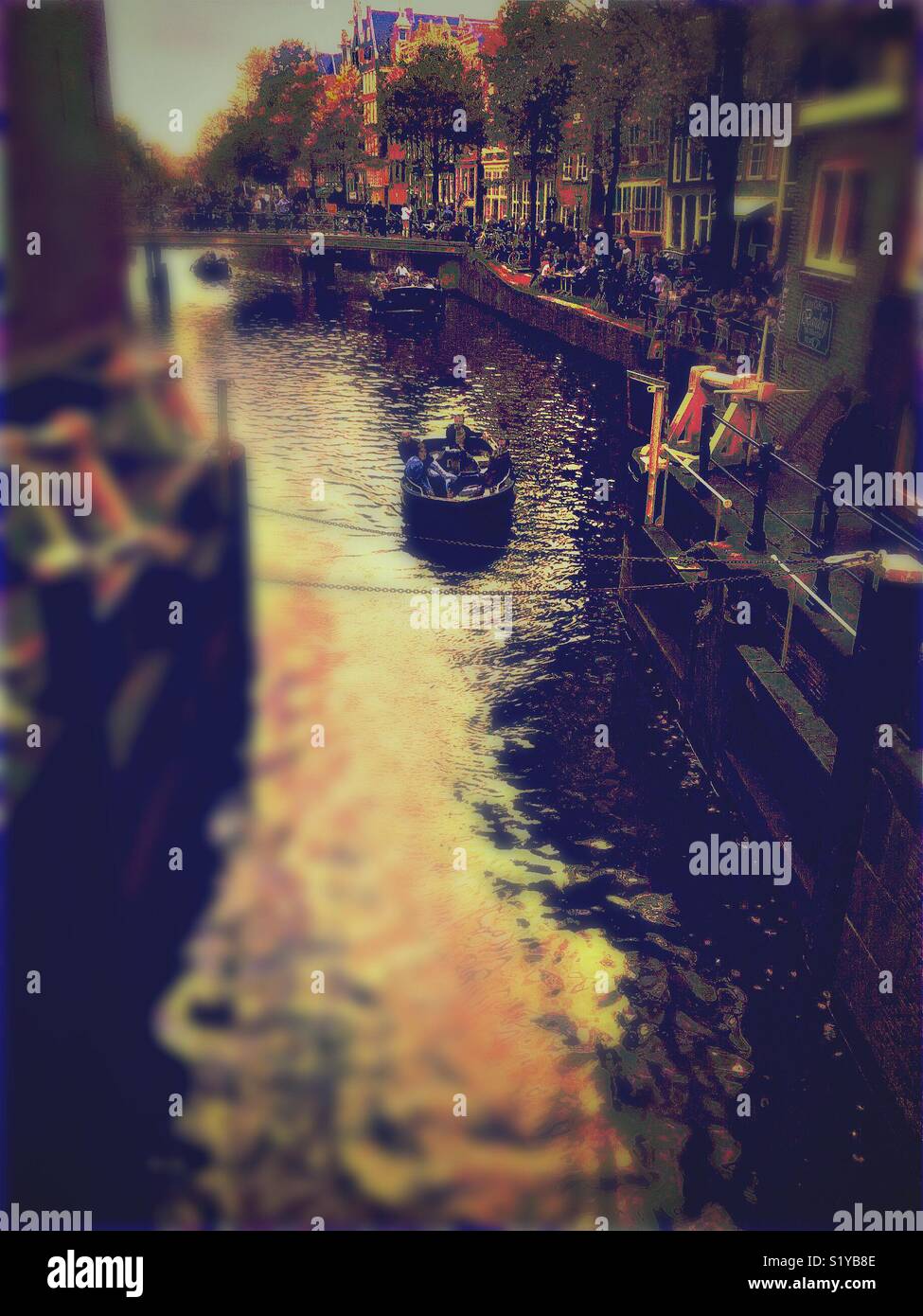 Tourists on bridge and canal boat blur, Amsterdam, Netherlands - Smartphone Captured Stock Image