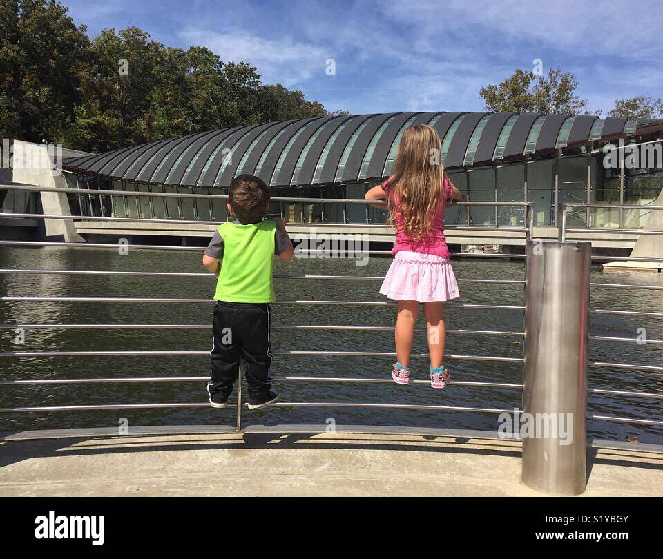 Two children look out over Crystal Springs at the Crystal Bridges Museum in Bentonville, Arkansas. - Smartphone Captured Stock Image