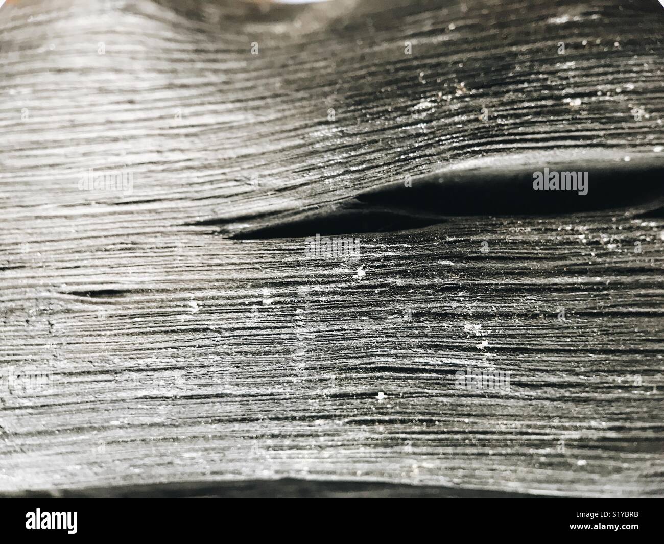 Macro of a stick of artisan Japanese active kishu charcoal, used to filter drinking water. - Smartphone Captured Stock Image