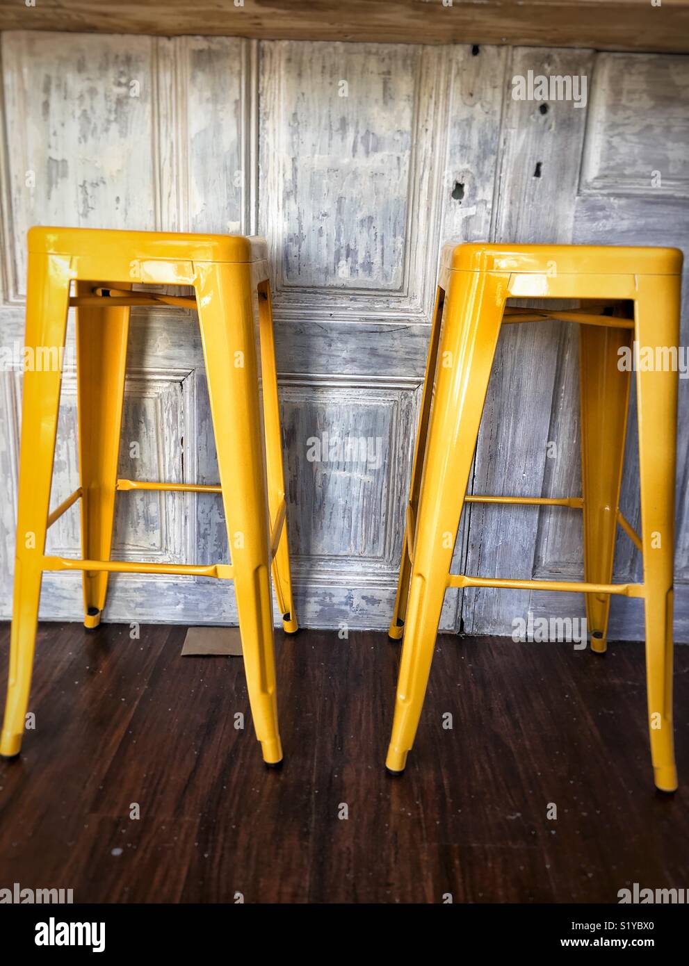 A pair of yellow stools Stock Photo Alamy