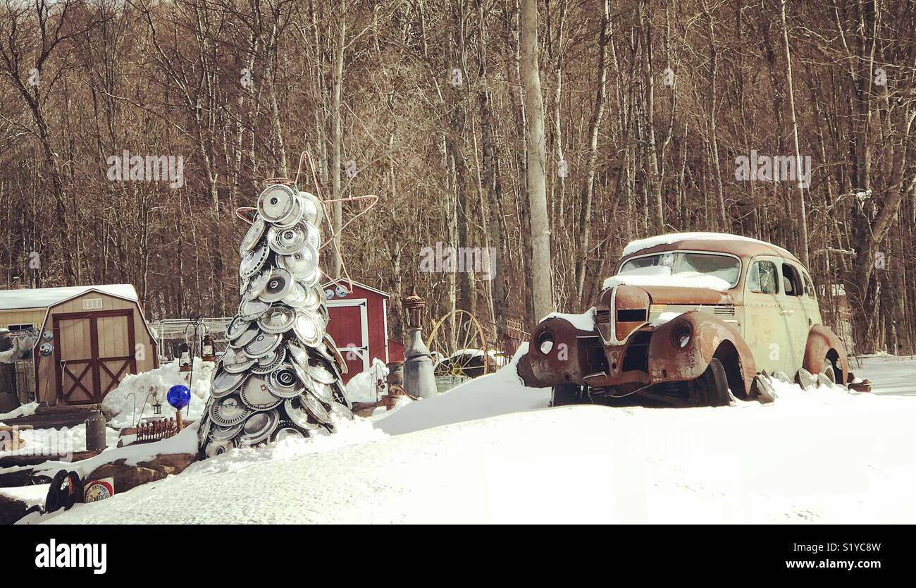 Old car and hubcap tree in the snow, Prompton, Wayne County, Pennsylvania Stock Photo